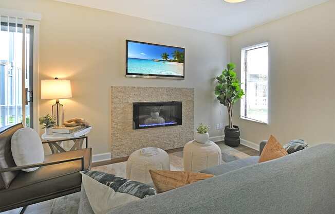 a living room with a fireplace and a tv above it
