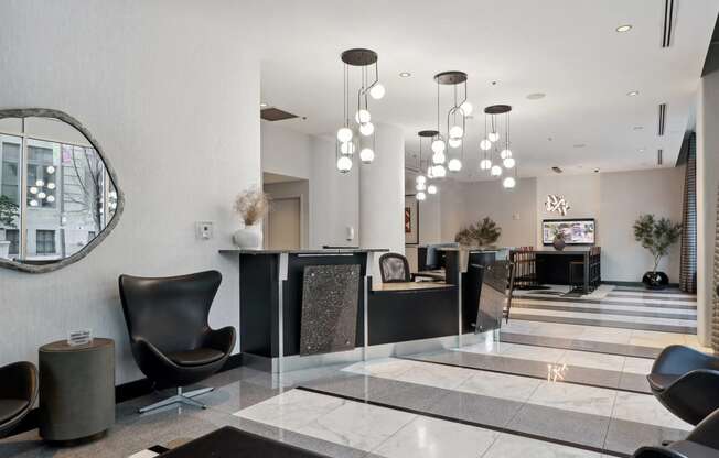 the lobby of a hotel with chairs and a reception desk