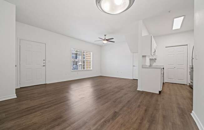 A room with wooden floors and white walls.