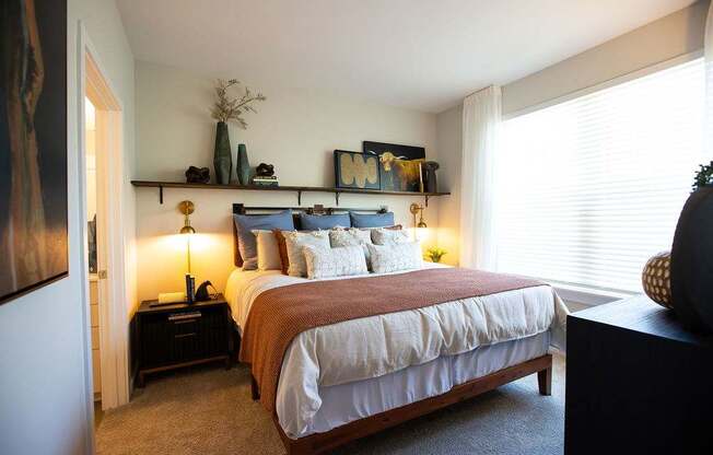 a bedroom with a bed and a window