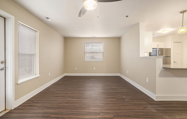 End style living room with wood flooring and an extra window  at Signature Pointe Apartment Homes, Athens, AL