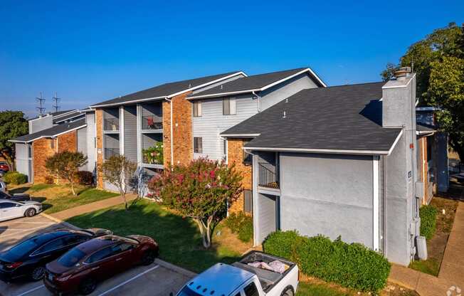 an apartment building with cars parked in front of it