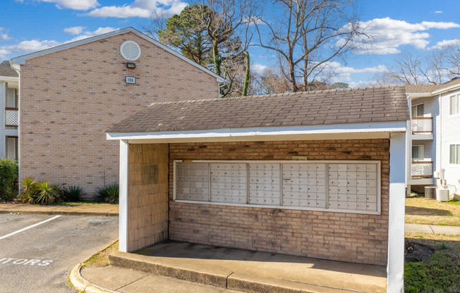 A brick building with a white awning and a calendar on the wall.