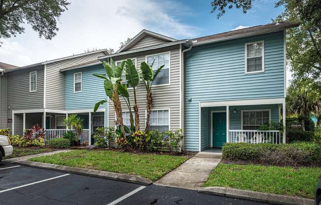 a blue house with palm trees in front of it