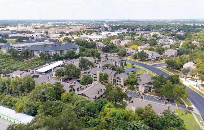 A bird's eye view of a residential area with houses and trees.