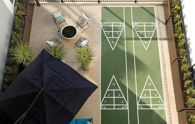 an aerial view of a patio with umbrellas and geometric patterns on the ground