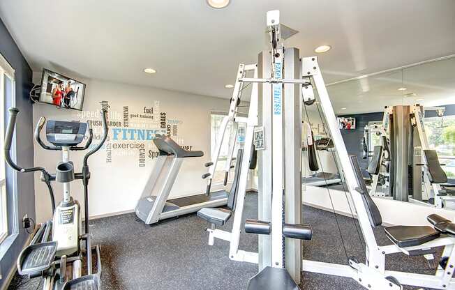 a gym with cardio machines and other exercise equipment