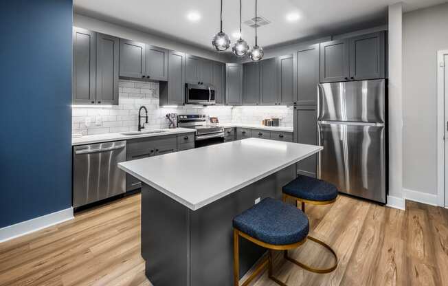 a kitchen with stainless steel appliances and a white counter top at The Alibi at Lake Lilly, Ocoee, FL