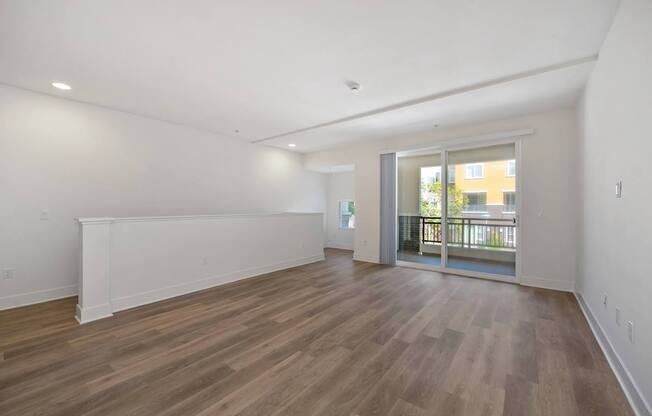 A room with wooden floors and white walls.