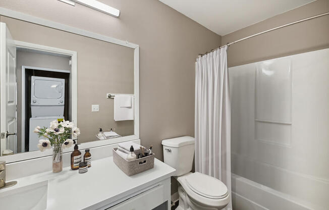 Model bathroom with white vanity at Vue at Baymeadows Apartments in Jacksonville, Florida