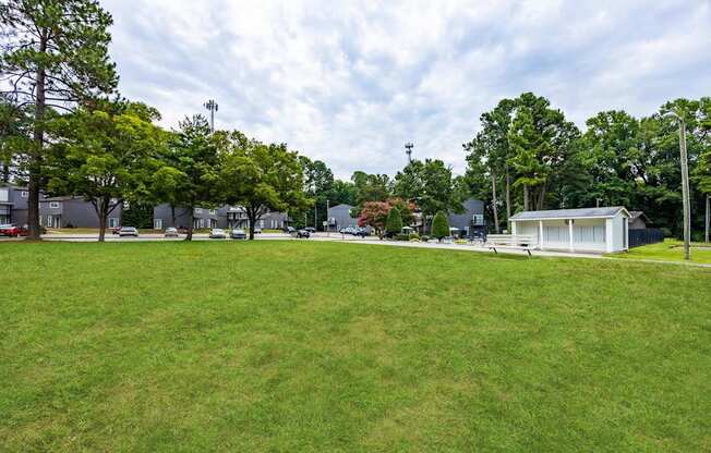 a park with a grassy field and a white building