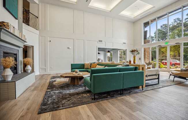 A living room with a green couch and a fireplace.