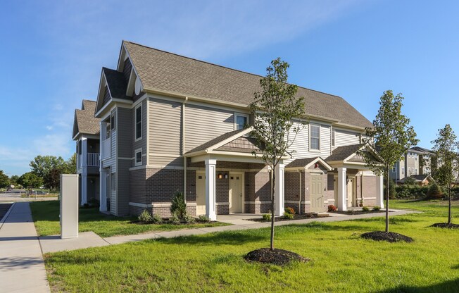 a house with a sidewalk and lawn in front of it