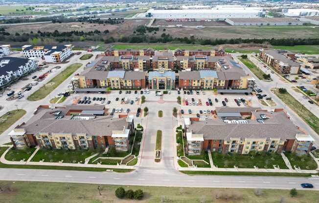 an aerial view of an apartment complex in a parking lot