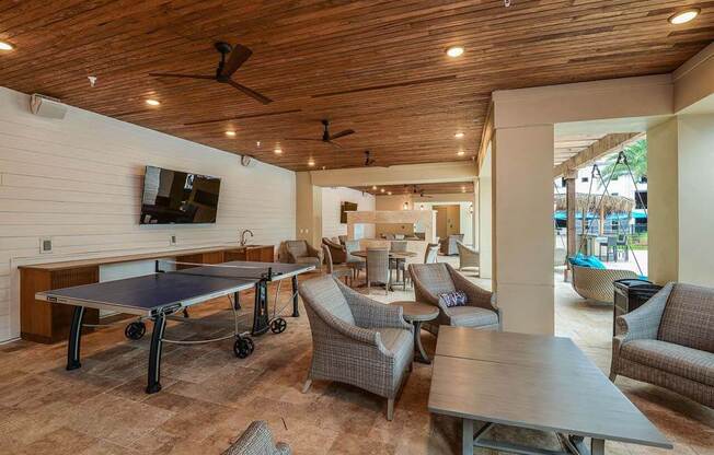 a patio with a ping pong table and chairs  at Palm Bay Club, Jacksonville, Florida