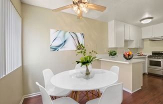 Dining area with ceiliing fan and kitchen on the right