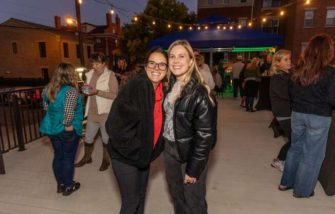 a couple of women posing for a picture at a party