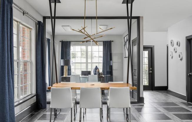 Table and chairs under contemporary chandelier in resident clubhouse at The Village at Auburn