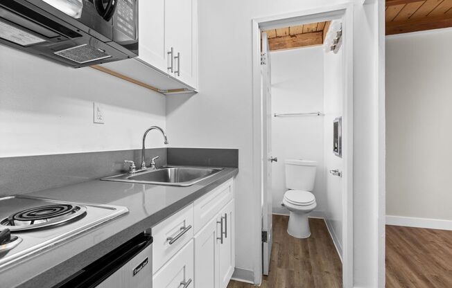 a kitchen with a stove top oven next to a sink