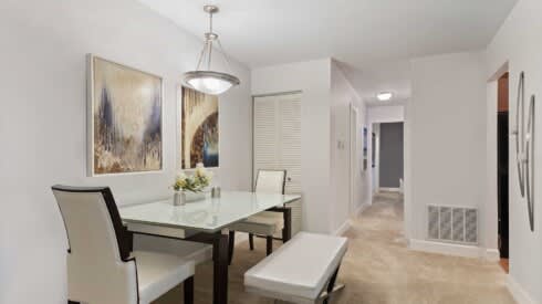 a dining room with a table and chairs
