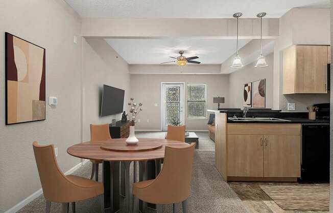 A modern dining room with a round table and chairs at Lynbrook Apartments and Townhomes, Elkhorn, NE, 68022