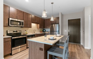 Kitchen with Dark Brown Cabinetry and Stainless Steel Appliances