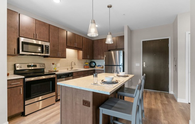 Kitchen with Dark Brown Cabinetry and Stainless Steel Appliances