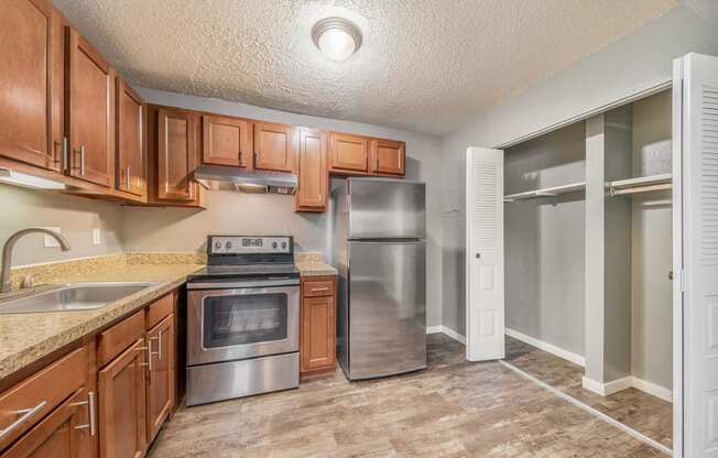 a kitchen with wooden cabinets and stainless steel appliances