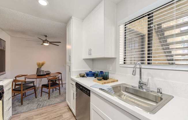A kitchen with a table and chairs in the middle of the room.