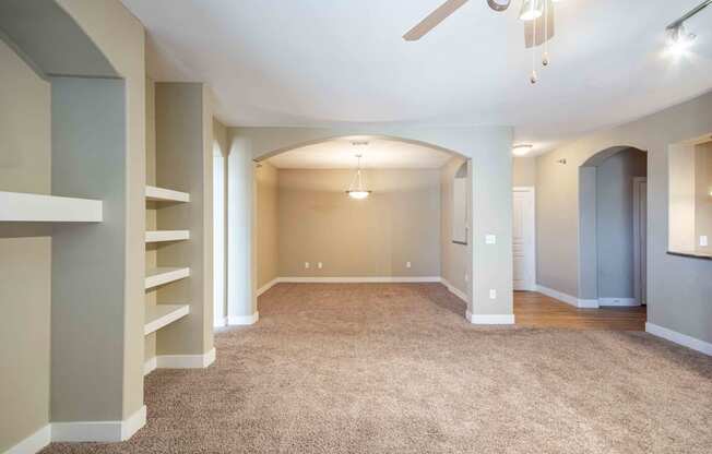 an empty room with a carpeted floor and a ceiling fan At Metropolitan Apartments in Little Rock, AR