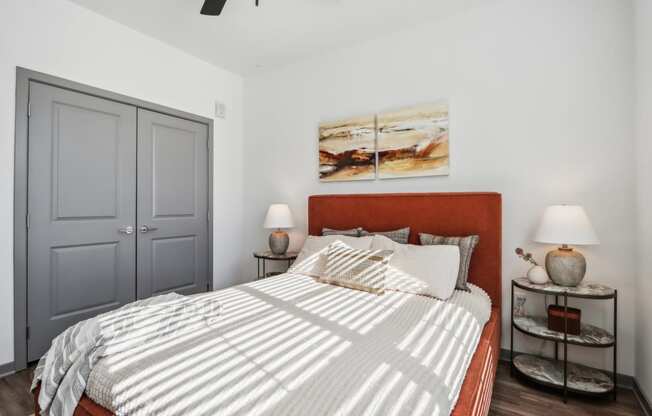 a bedroom with a bed and two lamps and a closet at Stella Luxury Apartment Homes, San Tan Valley