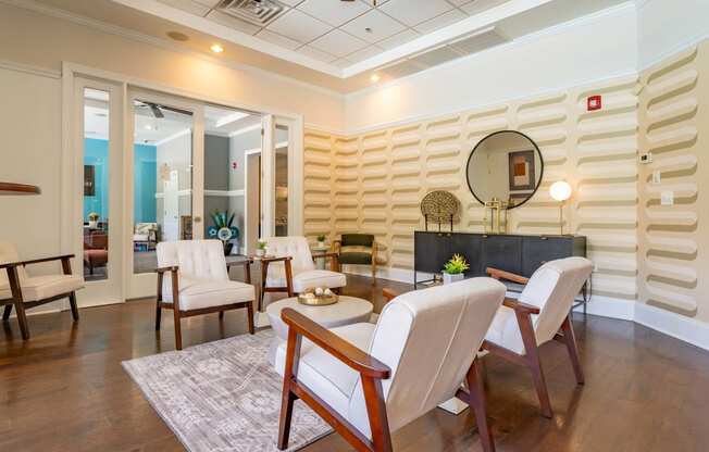 a living room with a table and chairs and a mirror