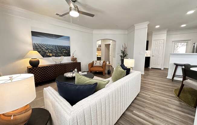 a living room with a couch and a ceiling fan