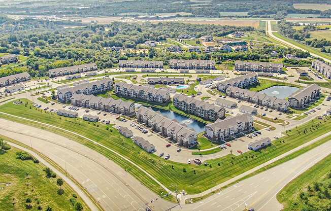A bird's eye view of an an apartment community with ponds at Strathmore Apartment Homes, West Des Moines, IA
