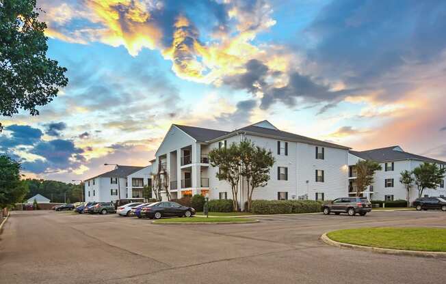 a street with cars parked in front of apartment buildings at Avalon Apartment Homes, Starkville, Mississippi, 39759