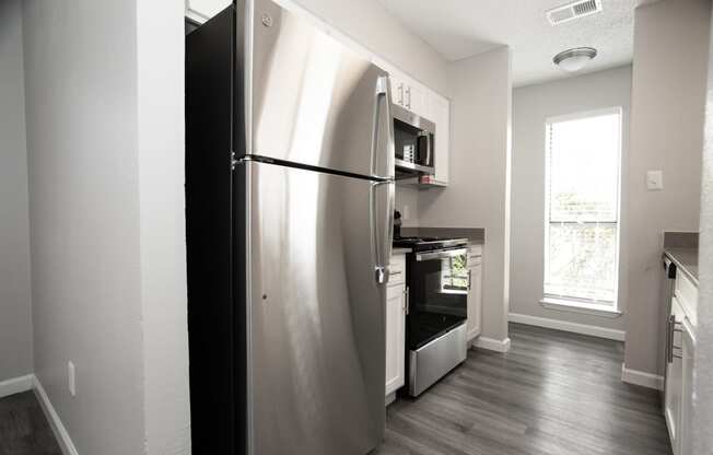 a stainless steel refrigerator and stove in a kitchen