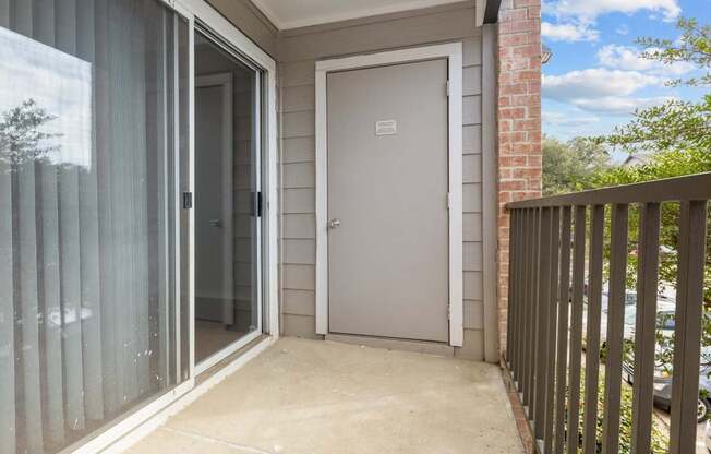A white door is on the side of a house.