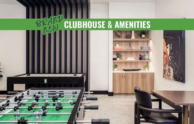 A foosball table is in the middle of a room with a green table top.