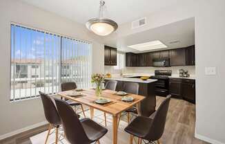 A modern dining room with a wooden table and chairs.
