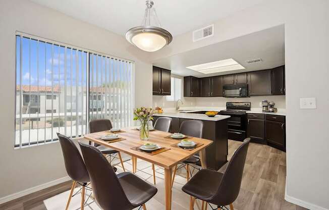 A modern dining room with a wooden table and chairs.