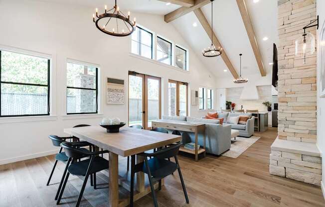 A dining room with a wooden table and chairs.