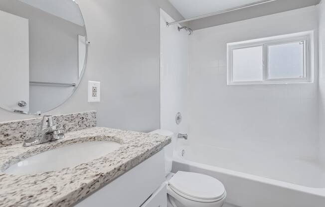 a bathroom with a sink and a toilet and a tub