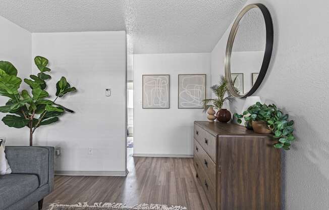 a living room with a dresser and a mirror