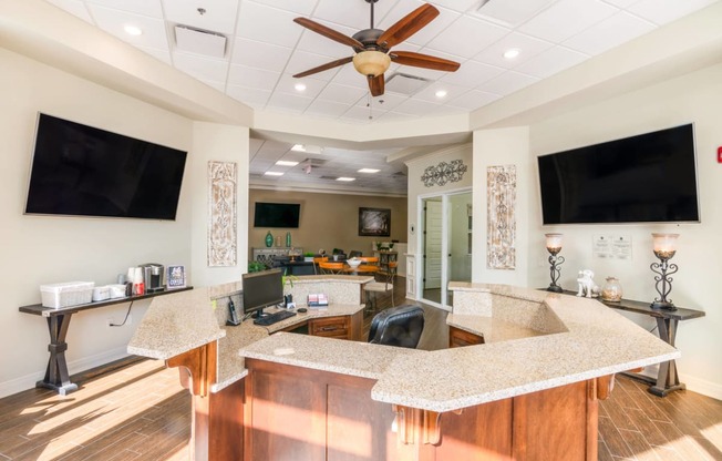 a kitchen with a counter top and a tv