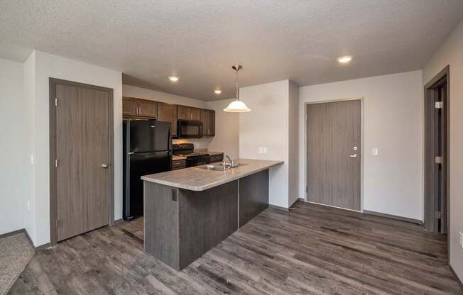 A kitchen with a wooden floor and a counter.