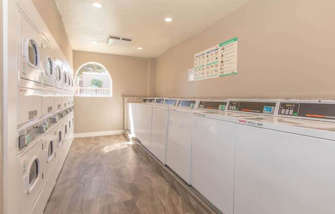 A row of washing machines in a public laundromat.
