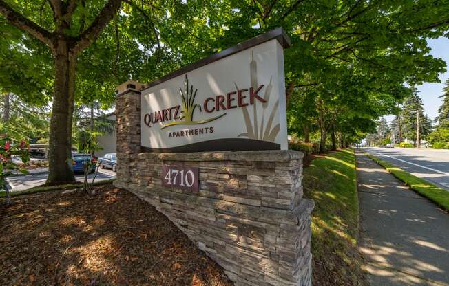 a sign for center creek apartments on the side of a road at Quartz Creek, Washington