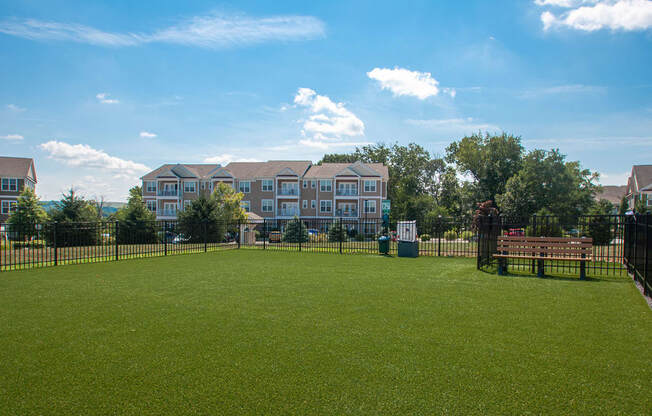 a large green lawn in front of an apartment complex