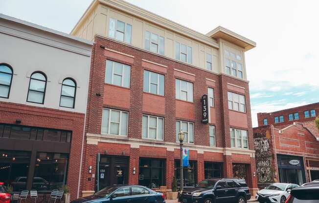 a large brick building with cars parked in front of it