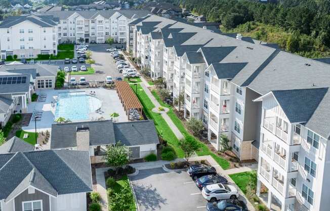 an aerial view of an apartment building with a swimming pool